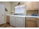 Functional laundry room with modern washer and dryer, ample cabinet space, and tiled countertops at 816 Sandsprings St, Henderson, NV 89011