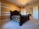 Bedroom with golden accents and chandelier as seen from upstairs hallway at 861 Majestic Ridge Ct, Henderson, NV 89052