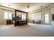 Bright and airy bedroom featuring a canopy bed, shutters, and plush carpeting at 861 Majestic Ridge Ct, Henderson, NV 89052