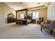 Spacious main bedroom boasts a canopy bed, sitting area, and ample natural light at 861 Majestic Ridge Ct, Henderson, NV 89052