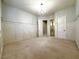 Spacious bedroom with neutral carpet, panelled walls, a chandelier, and open doorways at 861 Majestic Ridge Ct, Henderson, NV 89052