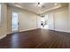 Spacious bedroom with hardwood floors, bright windows, and double doors leading to the foyer at 861 Majestic Ridge Ct, Henderson, NV 89052