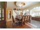 Elegant dining room features a chandelier, staircase, and formal dining set at 861 Majestic Ridge Ct, Henderson, NV 89052