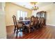Formal dining room with elegant chandelier, hardwood floors, and classic decor at 861 Majestic Ridge Ct, Henderson, NV 89052