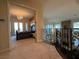 Upstairs hallway with decorative wrought iron railing leading to a bedroom with French doors at 861 Majestic Ridge Ct, Henderson, NV 89052