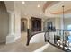 Elegant hallway with decorative iron railings, arched doorways, and custom built-in shelving at 861 Majestic Ridge Ct, Henderson, NV 89052
