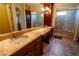 Main bathroom with double sink vanity, granite countertop, and glass enclosed shower at 861 Majestic Ridge Ct, Henderson, NV 89052