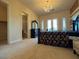 The main bedroom has neutral carpet and a doorway to the main bath and walk-in closet at 861 Majestic Ridge Ct, Henderson, NV 89052