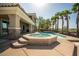 Resort-style pool and spa surrounded by palm trees and lush landscaping, perfect for outdoor entertaining at 861 Majestic Ridge Ct, Henderson, NV 89052