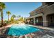 Inviting backyard pool with an attached waterfall feature and covered patio area ideal for relaxing at 861 Majestic Ridge Ct, Henderson, NV 89052