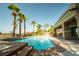 Beautiful pool with attached waterfall and desert landscaping creating a backyard oasis perfect for relaxing at 861 Majestic Ridge Ct, Henderson, NV 89052