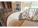 Beautiful curved staircase with carpeted steps and ornate wrought iron railing at 861 Majestic Ridge Ct, Henderson, NV 89052