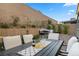 Inviting backyard featuring a dining area, fire pit, and seating, perfect for outdoor relaxation and entertaining at 8705 Fordster St, Las Vegas, NV 89166