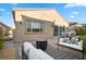 Inviting backyard with a covered patio, modern outdoor furniture, and easy access to the home at 8705 Fordster St, Las Vegas, NV 89166
