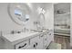 Elegant bathroom vanity with dual sinks, quartz countertop, and stylish mirrors at 8705 Fordster St, Las Vegas, NV 89166