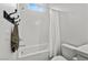Bright bathroom features a clean shower and tub combo with a white shower curtain and coordinating fixtures at 8705 Fordster St, Las Vegas, NV 89166