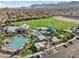 Aerial view of a neighborhood community center with pool, playground, and green space at 8705 Fordster St, Las Vegas, NV 89166