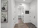 Hallway featuring decor, white walls, and doorways to other rooms in the home at 8705 Fordster St, Las Vegas, NV 89166