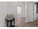 Hallway featuring stylish decor, neutral walls, and an entryway to other rooms in the home at 8705 Fordster St, Las Vegas, NV 89166