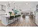 Bright, modern kitchen featuring white cabinets, a large island with bar seating, and pendant lighting at 8705 Fordster St, Las Vegas, NV 89166