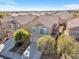 Aerial view of the charming home and the surrounding neighborhood with mountain views in the distance at 9171 Denver Sky Ave, Las Vegas, NV 89149