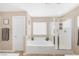 Bright bathroom features a tub and shower, tiled flooring, and a window providing natural light at 9171 Denver Sky Ave, Las Vegas, NV 89149
