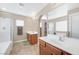 Bright bathroom featuring shower and bathtub, double sink vanity, tiled flooring, and a mirror at 9171 Denver Sky Ave, Las Vegas, NV 89149