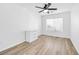 Bright bedroom with wood flooring, window with blinds, and a ceiling fan, offering comfort and style at 9171 Denver Sky Ave, Las Vegas, NV 89149