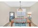 The dining room with modern lighting fixtures, table, and six chairs at 9171 Denver Sky Ave, Las Vegas, NV 89149