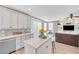 Open kitchen with white cabinets and stainless appliances, seamlessly connected to the living area at 9171 Denver Sky Ave, Las Vegas, NV 89149