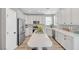 Beautiful kitchen with white cabinets, stainless steel appliances and a center island with seating at 9171 Denver Sky Ave, Las Vegas, NV 89149