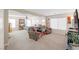 Open main bedroom with an adjacent sitting area featuring two arm chairs and a large tv at 9171 Denver Sky Ave, Las Vegas, NV 89149