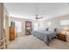Spacious main bedroom features plush carpet, ceiling fan, and large windows at 9171 Denver Sky Ave, Las Vegas, NV 89149