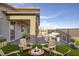 Inviting backyard with fire pit, multiple seating areas and lush artificial turf at 924 Mayfield Manor Ln, Las Vegas, NV 89138