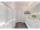 Bright bathroom features a double sink vanity with framed mirror and glass shower with chrome hardware at 924 Mayfield Manor Ln, Las Vegas, NV 89138