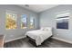 Bright bedroom featuring three windows and hardwood floors, providing ample natural light at 924 Mayfield Manor Ln, Las Vegas, NV 89138