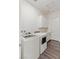 Laundry room with modern, front-load washer and dryer, and ample storage cabinets at 924 Mayfield Manor Ln, Las Vegas, NV 89138