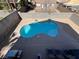 Aerial view of uniquely-shaped pool with outdoor furniture and privacy wall surrounding the yard at 9328 Jumpin Juniper Ave, Las Vegas, NV 89129