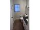 Cozy bathroom features a toilet, stylish vanity, and window with natural light at 9328 Jumpin Juniper Ave, Las Vegas, NV 89129
