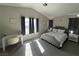 Well-lit bedroom features a comfortable bed and modern décor, creating a relaxing atmosphere at 9328 Jumpin Juniper Ave, Las Vegas, NV 89129