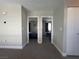 Neutral bedroom shows two entryways to two bedrooms, both with beds and window coverings at 9328 Jumpin Juniper Ave, Las Vegas, NV 89129