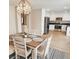 Inviting dining area with modern chandelier, wood table, and easy access to the kitchen at 9328 Jumpin Juniper Ave, Las Vegas, NV 89129