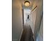 Neutral colored hallway with carpet and bright lighting fixture at 9328 Jumpin Juniper Ave, Las Vegas, NV 89129