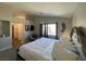 A bright main bedroom showcases modern decor, a comfortable accent chair, and access to the ensuite at 9328 Jumpin Juniper Ave, Las Vegas, NV 89129