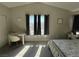 Sunny primary bedroom features a desk by the window, side table and bed at 9328 Jumpin Juniper Ave, Las Vegas, NV 89129