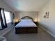 Well-lit main bedroom featuring a king-size bed with upholstered headboard and soft white bedding at 9328 Jumpin Juniper Ave, Las Vegas, NV 89129