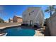 Backyard pool with lounge chairs, barbecue, gravel surround and privacy wall at 9328 Jumpin Juniper Ave, Las Vegas, NV 89129