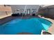 Inviting backyard swimming pool with lounge area for outdoor relaxation at 9328 Jumpin Juniper Ave, Las Vegas, NV 89129