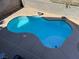 Top down view of a backyard pool surrounded by desert landscaping and a privacy wall at 9328 Jumpin Juniper Ave, Las Vegas, NV 89129