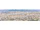 An aerial view shows a community of homes with mountain and city skyline views at 9527 Havasu Canyon Ave, Las Vegas, NV 89166